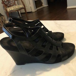 Black leather wedged sandals.